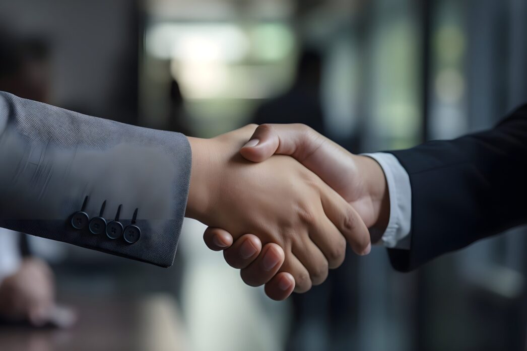 vecteezy_two-business-people-shaking-hands-in-an-office-generative-ai_30763580_308-scaled-e1698862502522